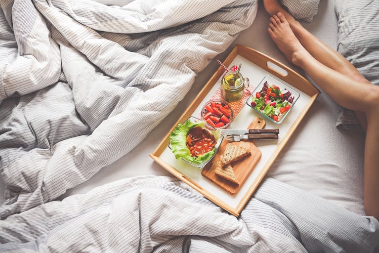 Enjoy a delightful morning with a healthy breakfast on a wooden tray, perfect for a relaxing start to the day.