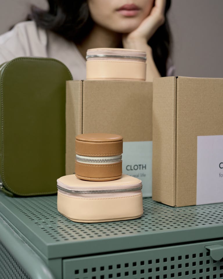 Stylish bags and packaging displayed in a minimalist studio with an elegant touch.